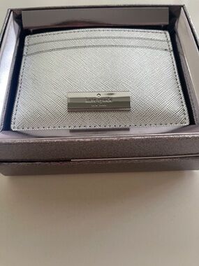 kate spade metallic silver card case with logo plaque
